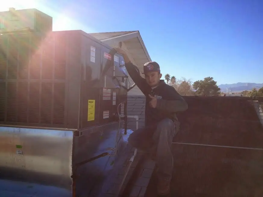 HVAC technician performing AC Tune-Up on a rooftop unit in Safety Harbor